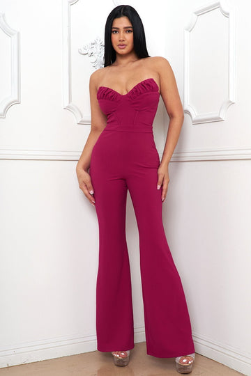 Magenta strapless corset jumpsuit with a sweetheart neckline and flared legs for a chic evening look from Boutinie.