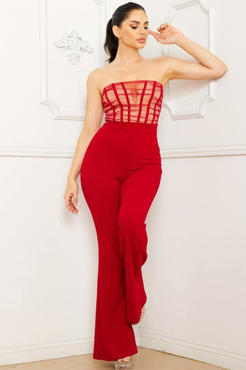 Red strapless jumpsuit featuring a sheer mesh corset bodice and wide-leg trousers for a stylish evening look.
