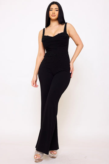 Black sleeveless formal jumpsuit with beaded bodice, square neckline, and flared legs from Boutinie.