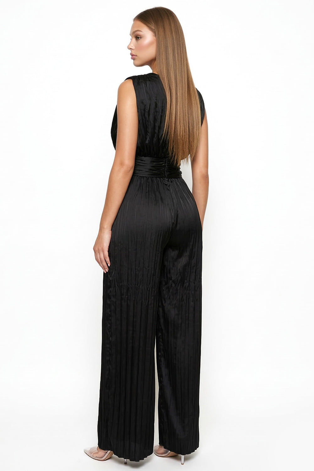 Sleek black pleated jumpsuit with a cinched waist and sleeveless silhouette, perfect for evening wear at Boutinie.