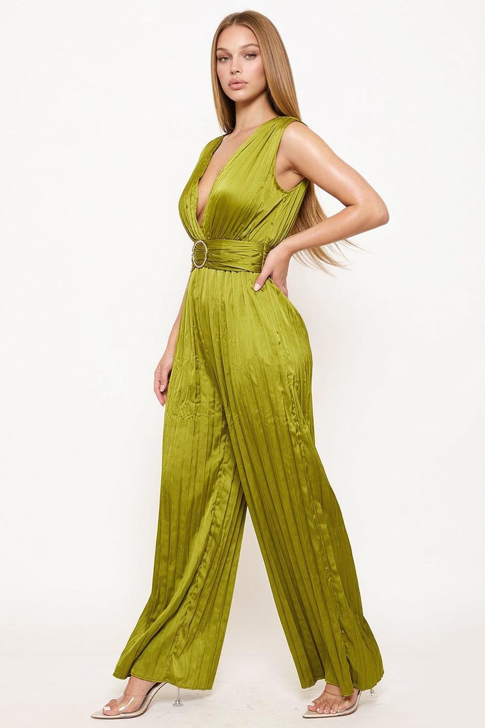 Model wearing a sleeveless olive green pleated satin jumpsuit with a plunging neckline and belted waist for events.