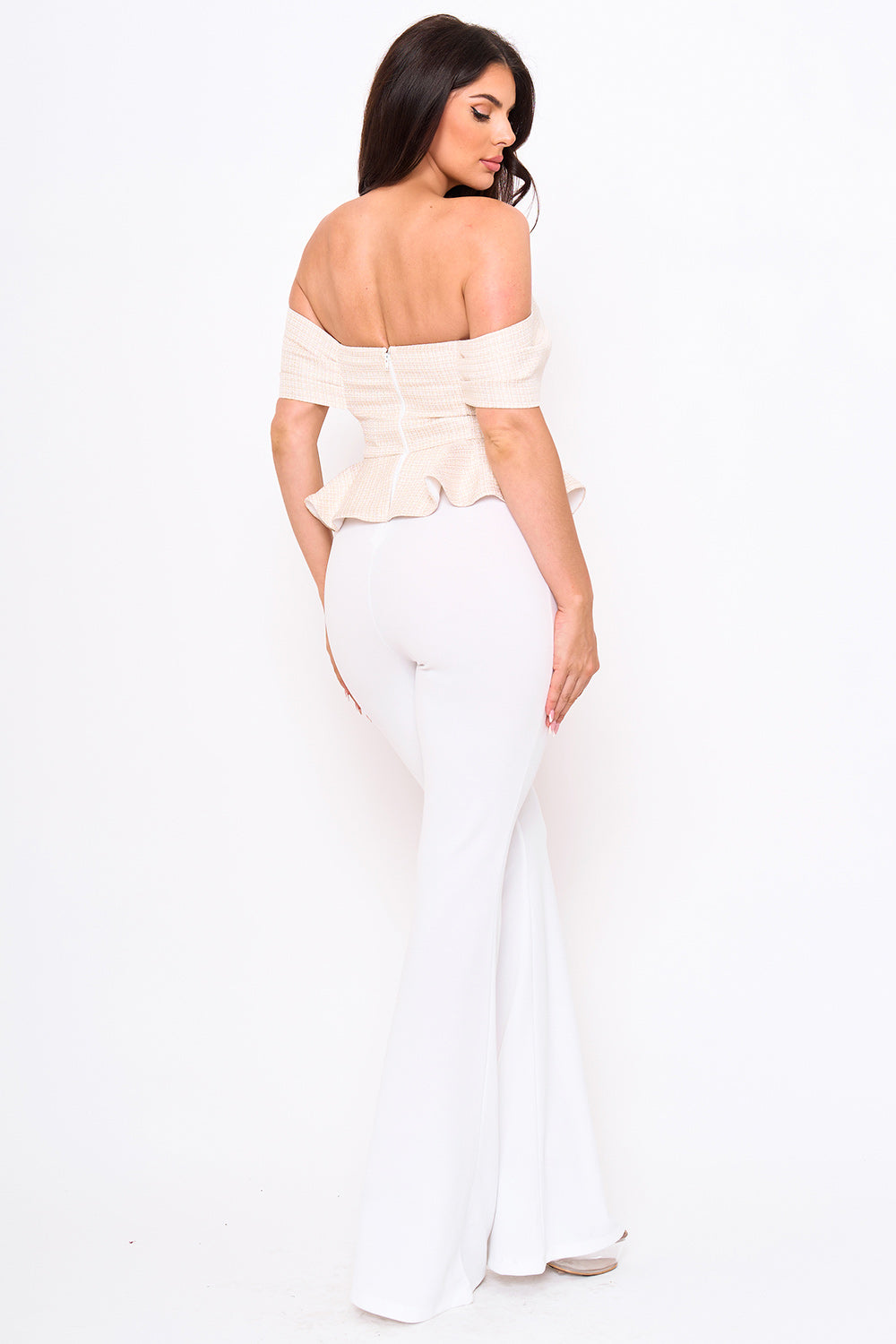 Beige tweed off-shoulder peplum top with white flared trousers for a chic, sophisticated evening look at Boutinie.