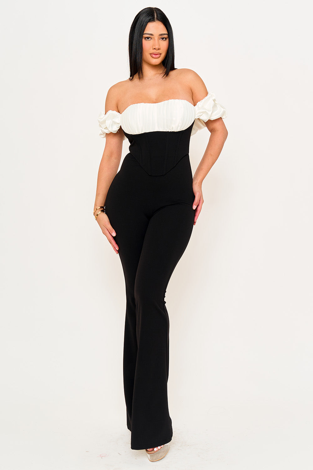 Boutinie black and white corset jumpsuit with off-shoulder puff sleeves and pleated bodice for a chic evening look.