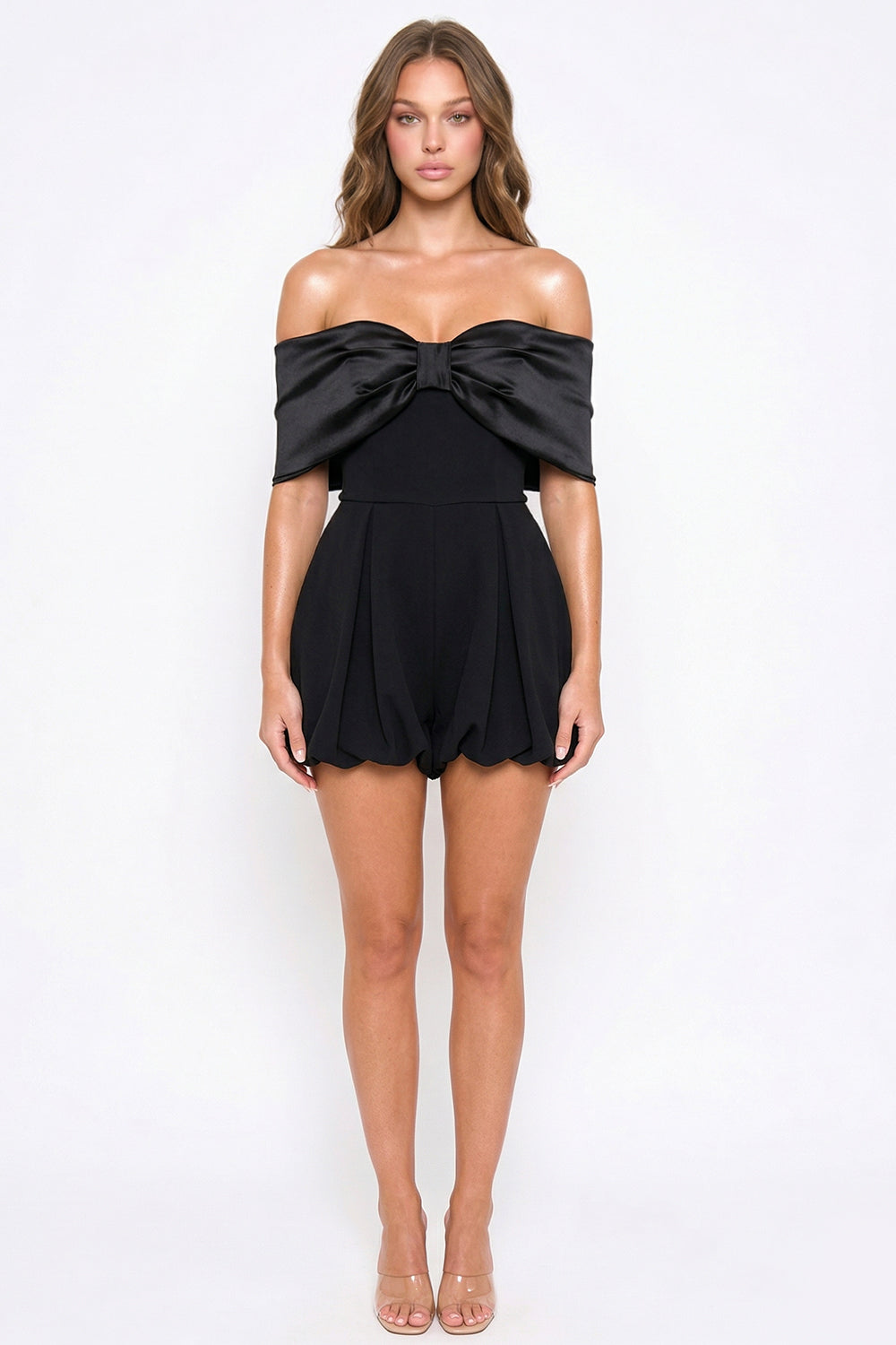 Black strapless party romper featuring a satin bow bodice and structured pleated bubble shorts by Boutinie.