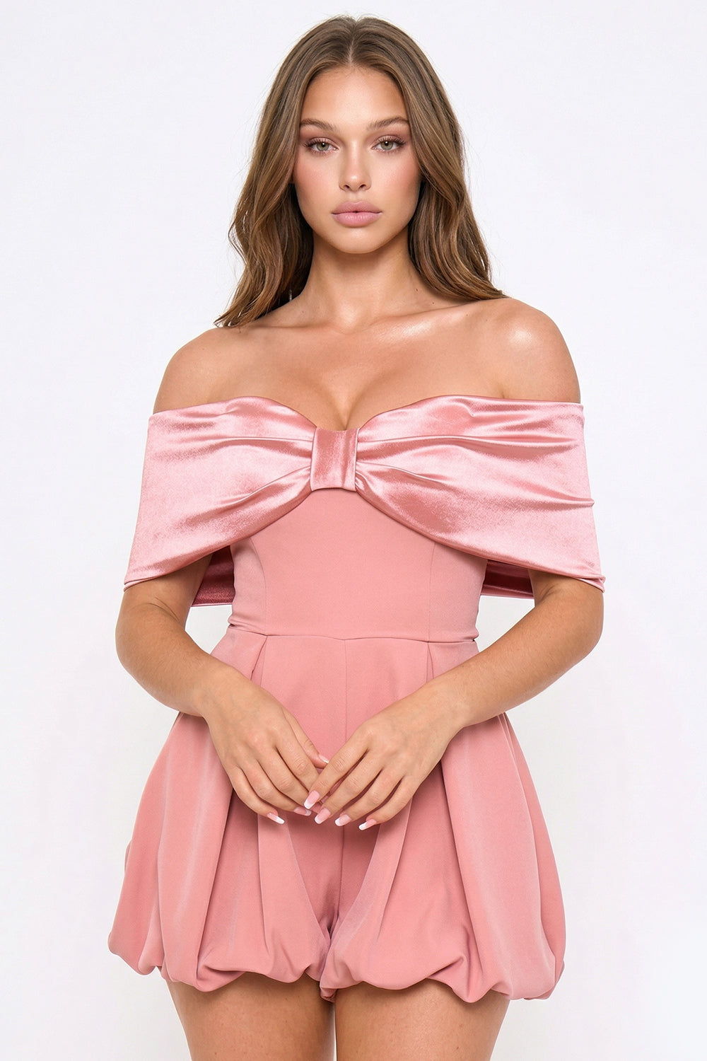 Dusty rose off-the-shoulder party romper featuring a satin bow neckline and a pleated bubble silhouette.