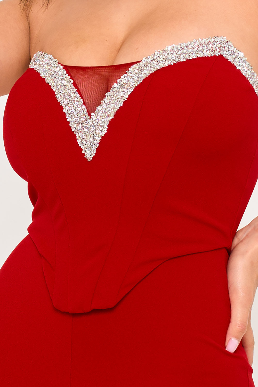 Red strapless corset top with crystal embellishment and sweetheart neckline, perfect for a glamorous evening look.