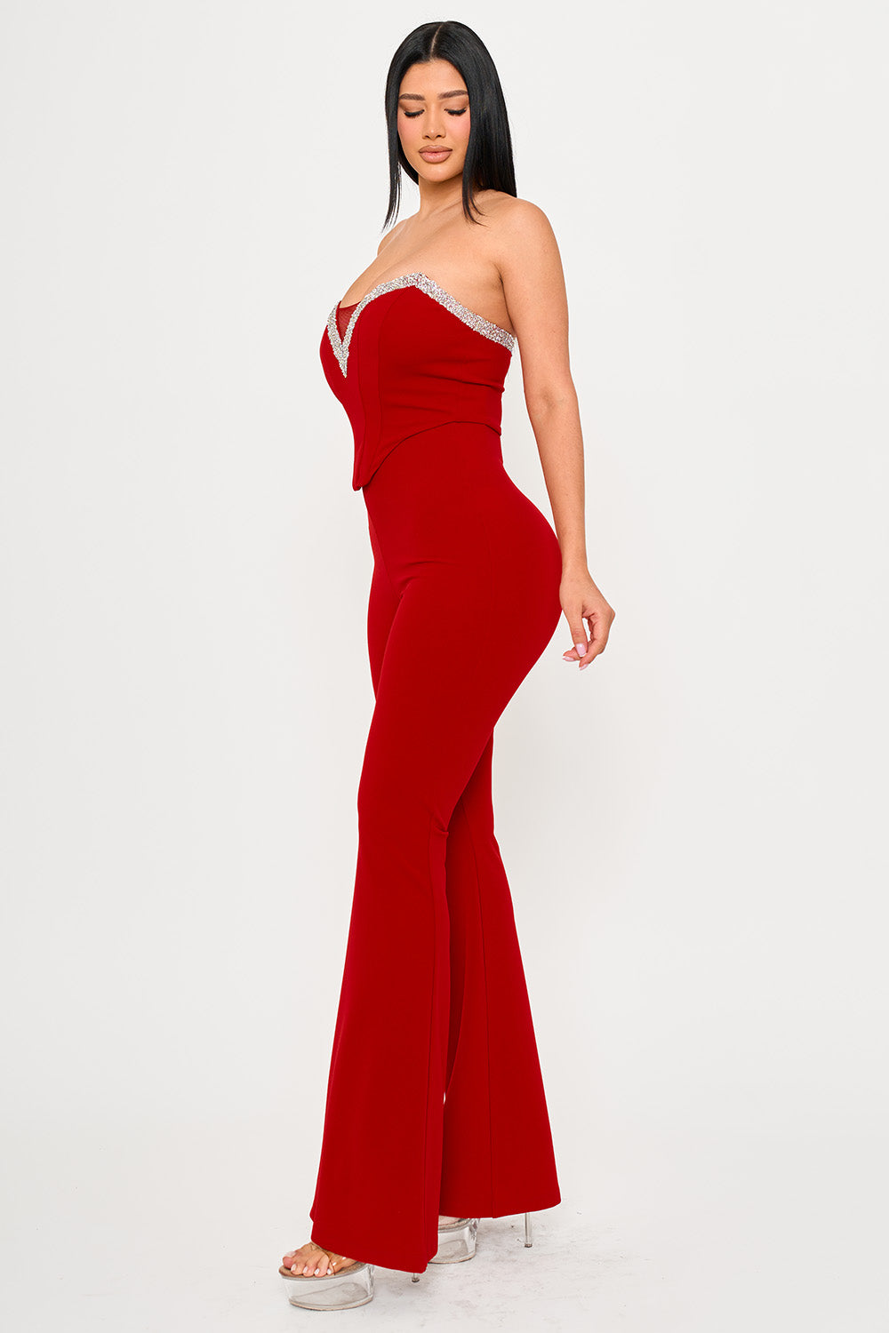 Boutinie red strapless jumpsuit featuring a crystal-embellished sweetheart neckline and flared legs for parties.