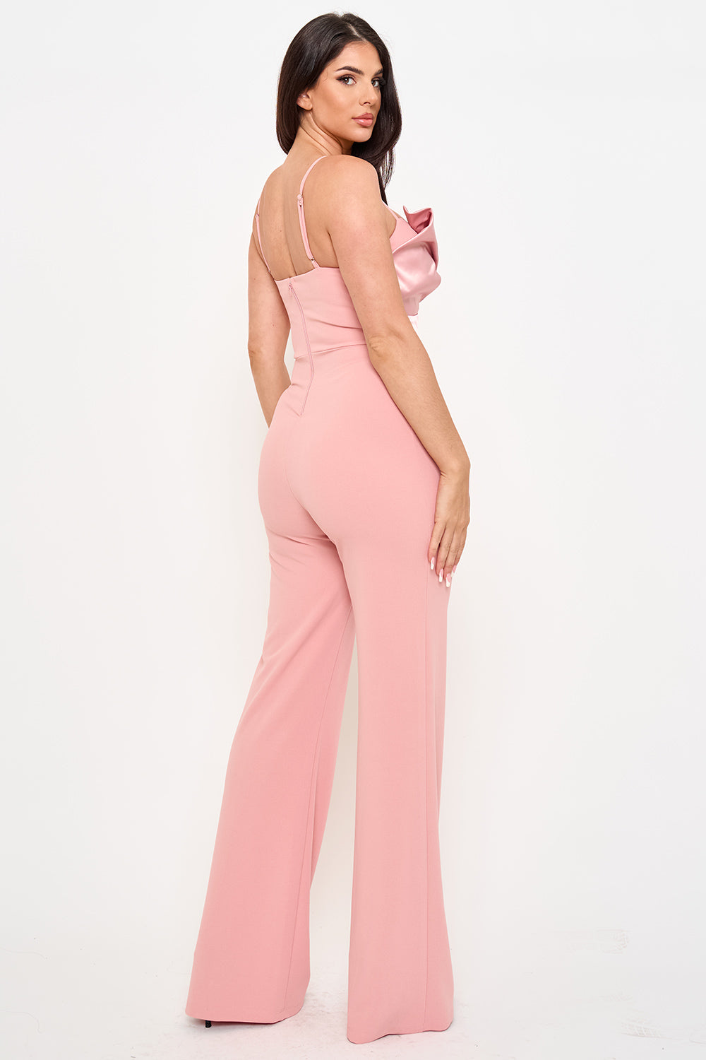 Dusty pink wide-leg jumpsuit with satin ruffle bodice and spaghetti straps, perfect for formal evening occasions.