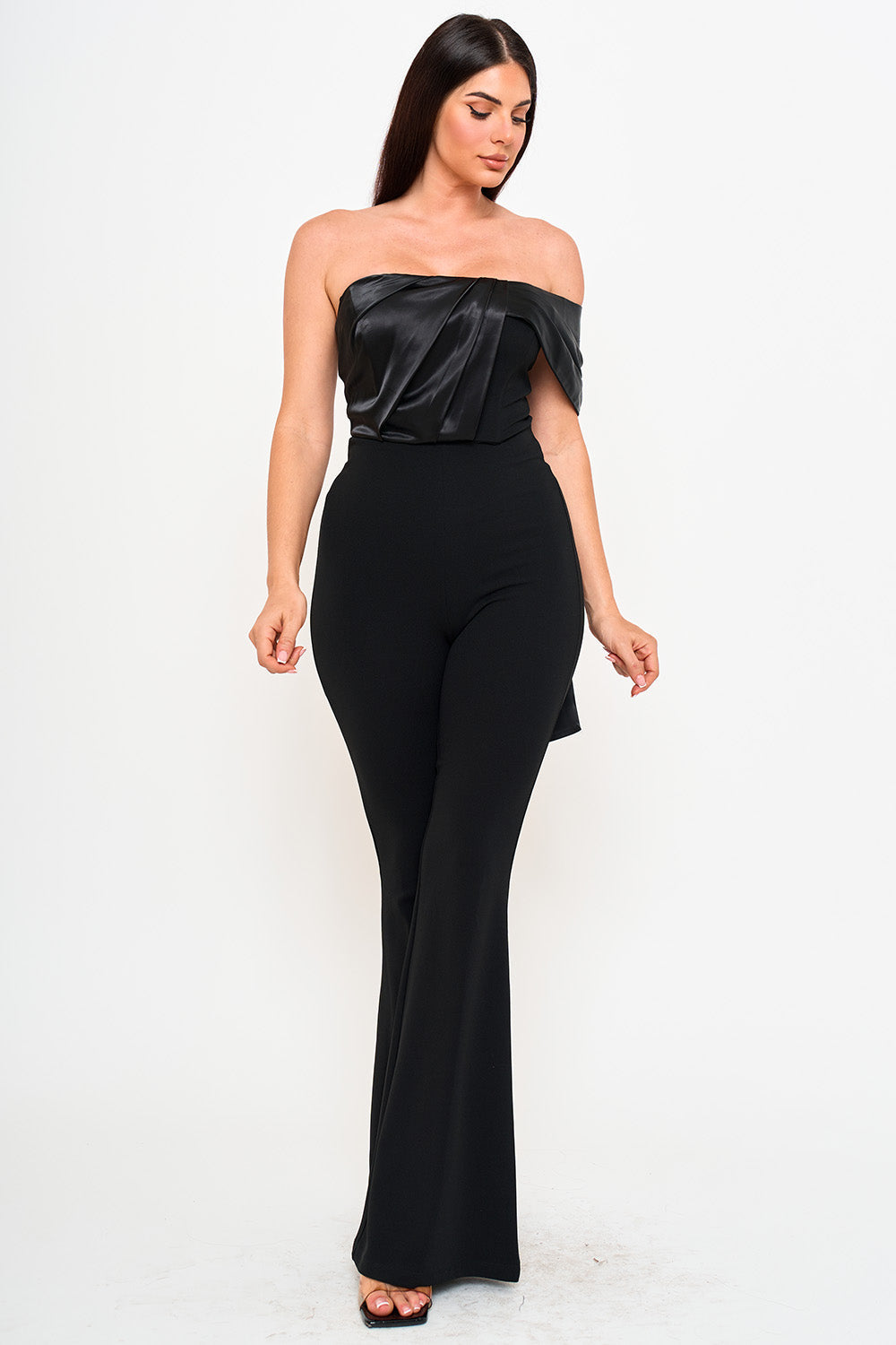 Black strapless jumpsuit with pleated satin bodice and flared trousers for an elegant evening look from Boutinie.