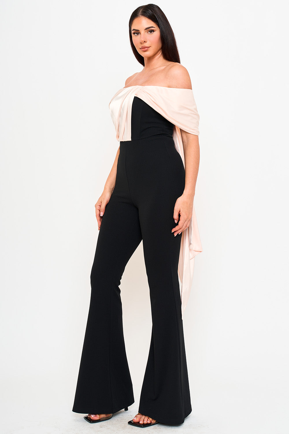 Boutinie black off-shoulder jumpsuit with a draped blush satin bodice and flared legs for an elegant evening look.