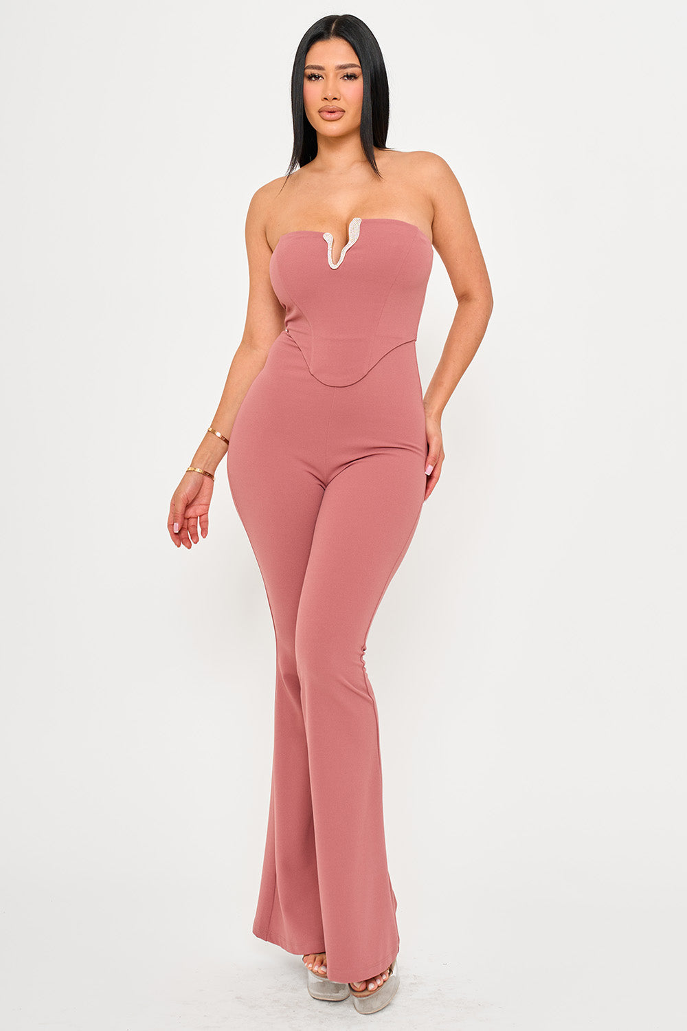 Dusty rose strapless corset jumpsuit with a V-neckline and flared legs for a chic evening look from Boutinie.