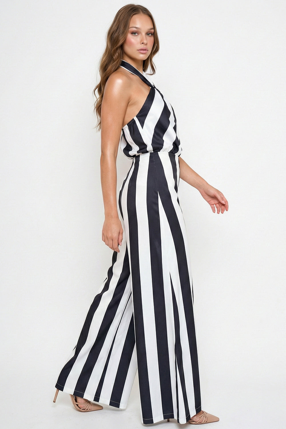Black and white striped halter-neck jumpsuit with a wide-leg silhouette for a chic evening look from Boutinie.
