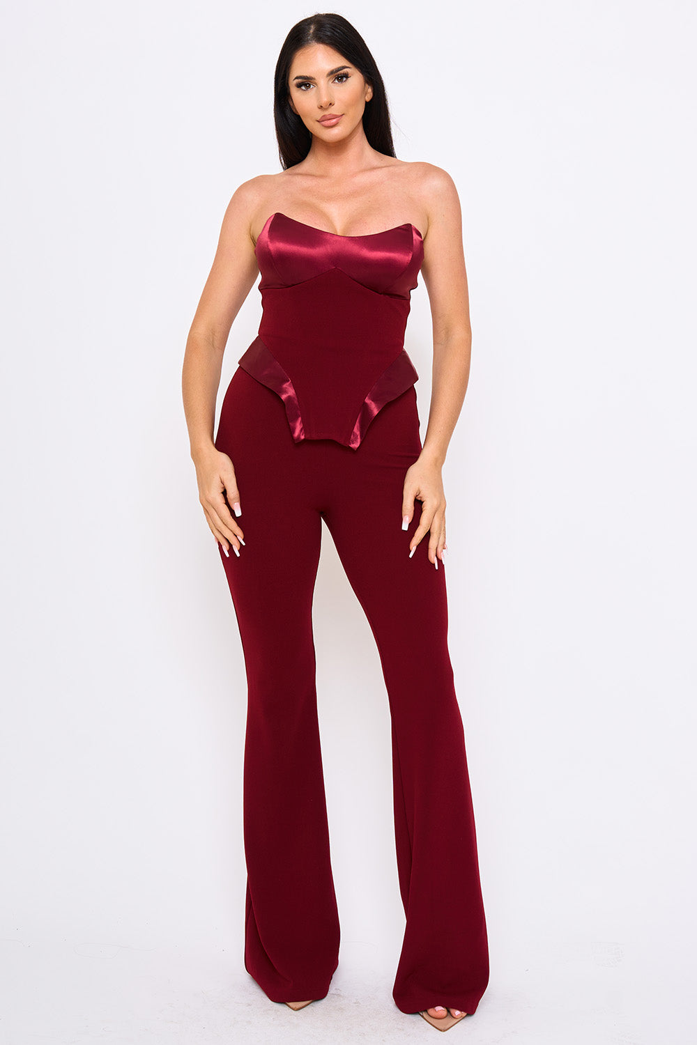 Boutinie burgundy strapless corset jumpsuit with satin bust detail and flared legs for a formal evening look.