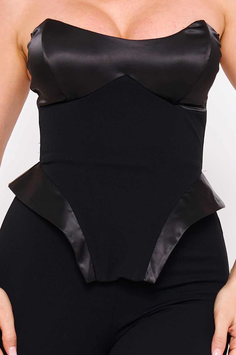 Black strapless corset top with satin panels and peplum waist for a chic evening look from Boutinie.