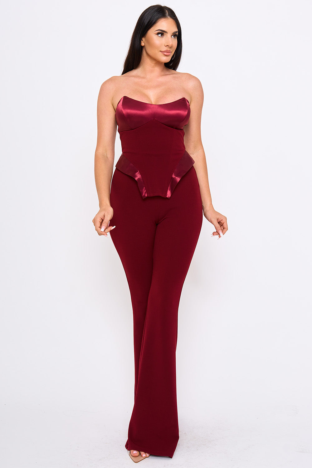 Burgundy strapless jumpsuit with satin corset bodice and slim-leg fit, perfect for elegant evening occasions.