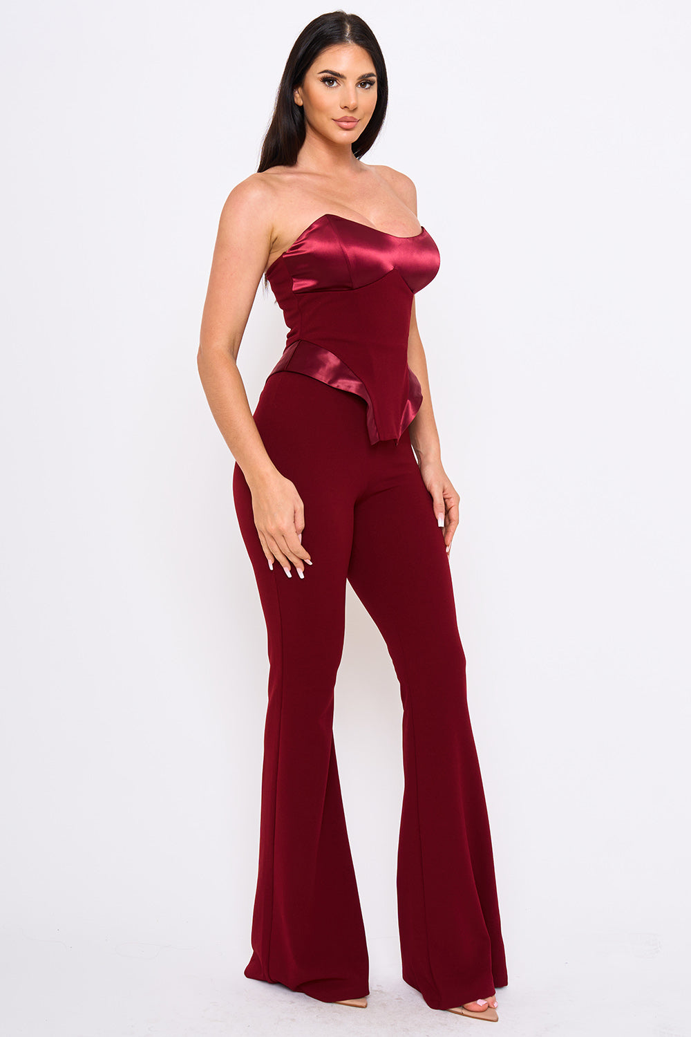 Burgundy strapless satin corset top and matching high-waisted flared trousers for a chic evening look from Boutinie.