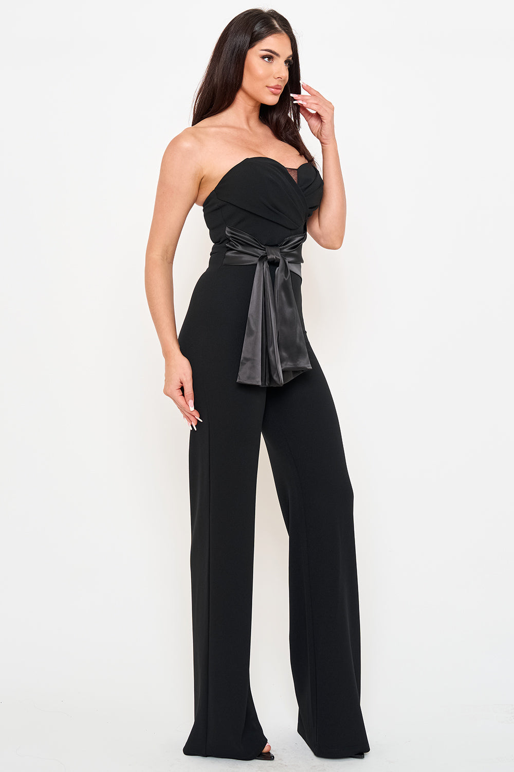 Black strapless formal jumpsuit with a satin waist tie and wide-leg silhouette from Boutinie.