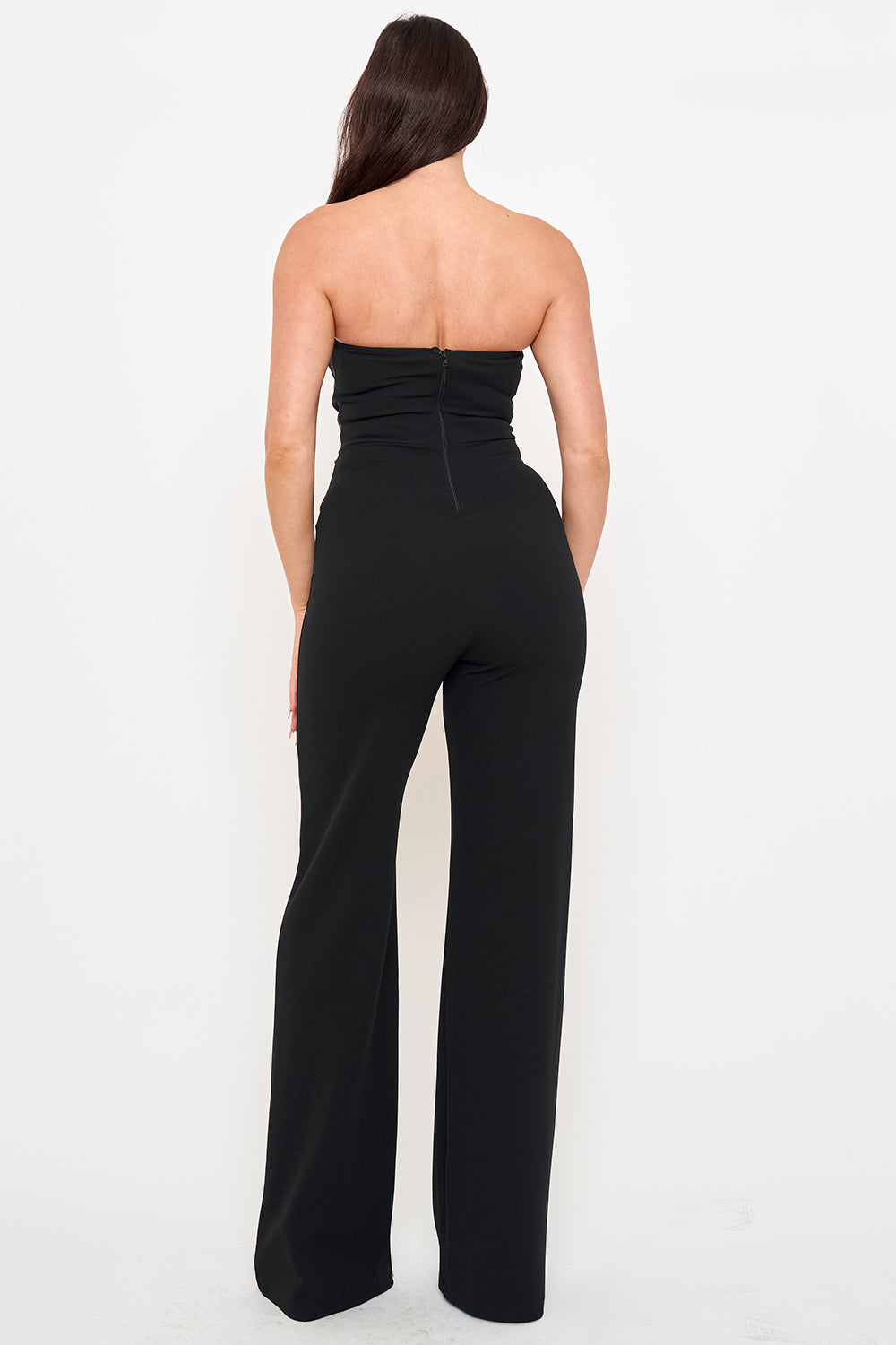 Back view of a chic black strapless jumpsuit with wide-leg silhouette, perfect for elegant evening wear.