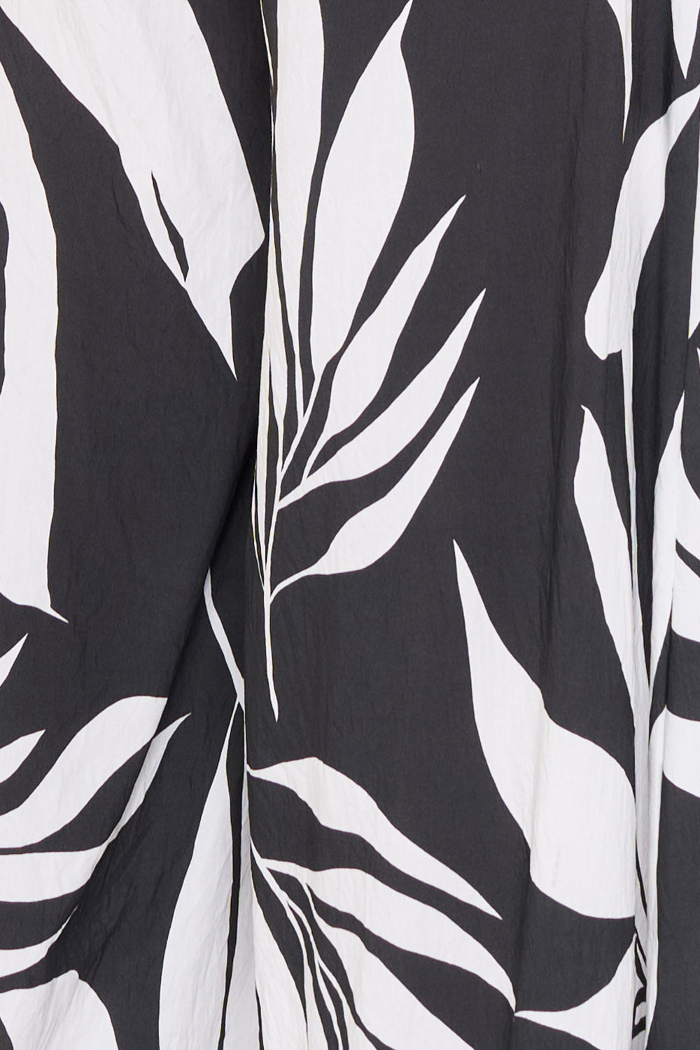 Boutinie black and white tropical leaf print fabric, lightweight textured material for a stylish summer dress.