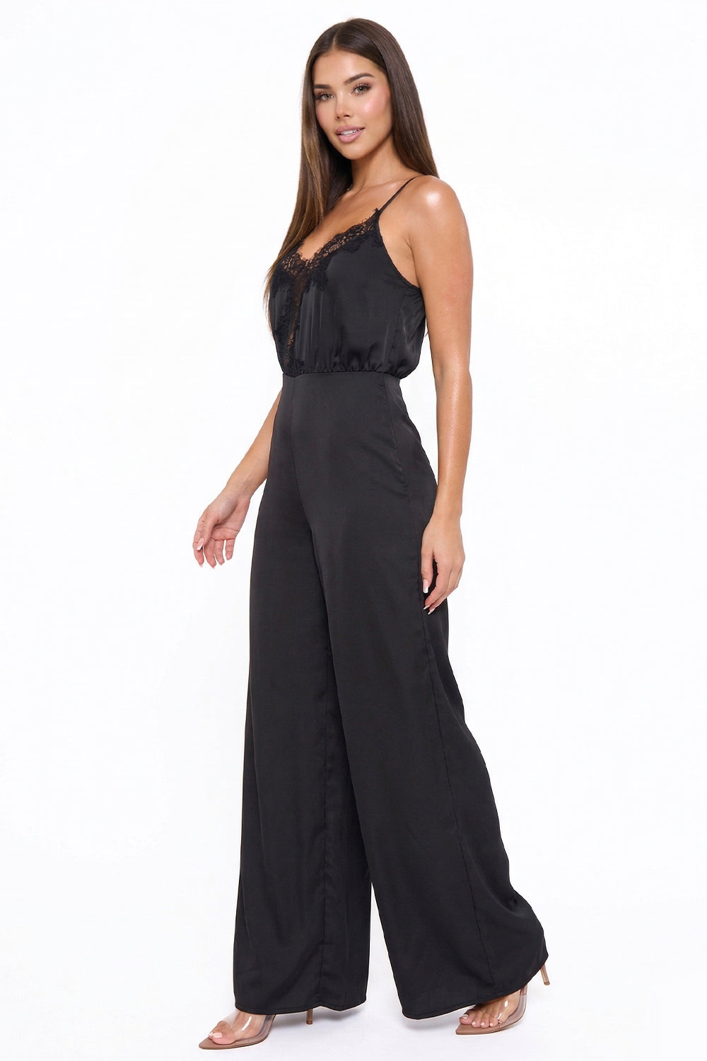 Black satin jumpsuit with a lace-trimmed V-neck, spaghetti straps, and wide legs, perfect for an evening event.