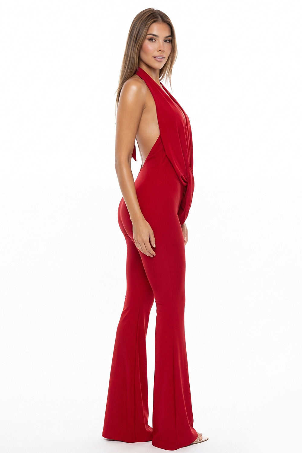 Red backless halter jumpsuit from Boutinie with a draped bodice and flared legs, perfect for a formal evening look.