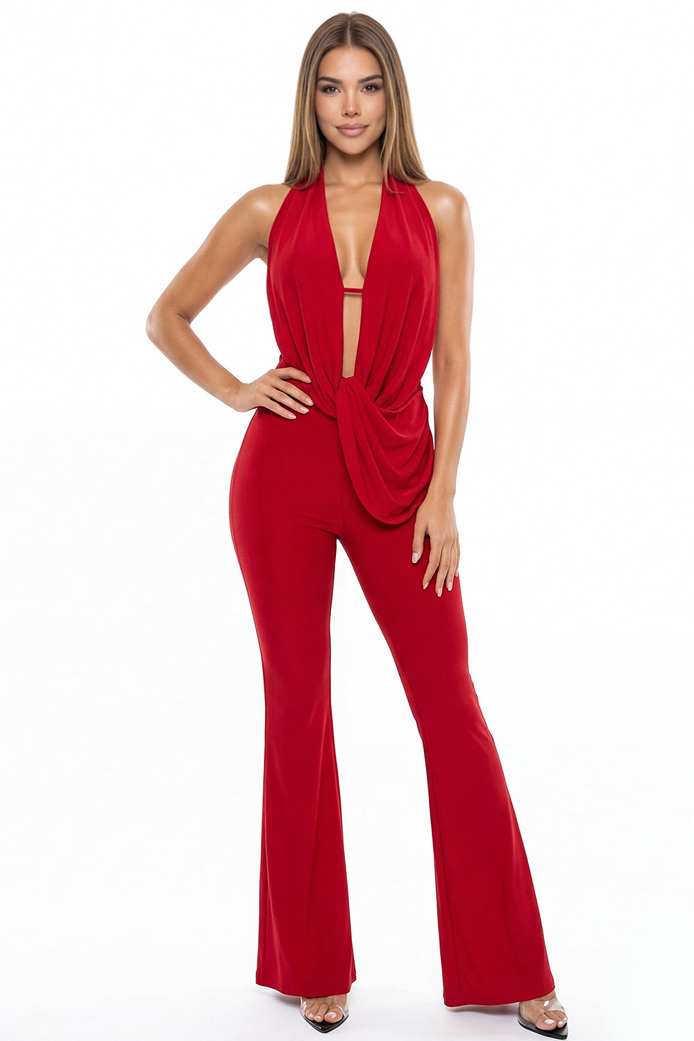 Red halter jumpsuit with a deep plunge neckline, draped bodice, and flared leg for a glam evening look by Boutinie.