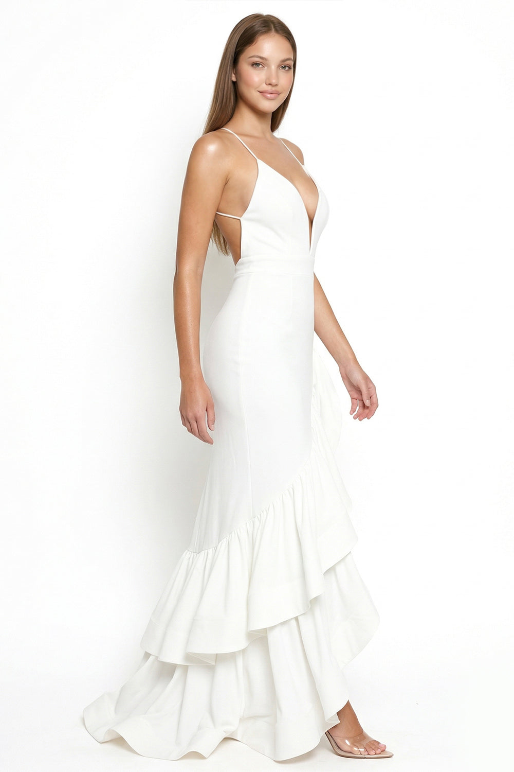 White sleeveless maxi dress with deep V-neck, open back, and tiered ruffle hem, perfect for formal events.