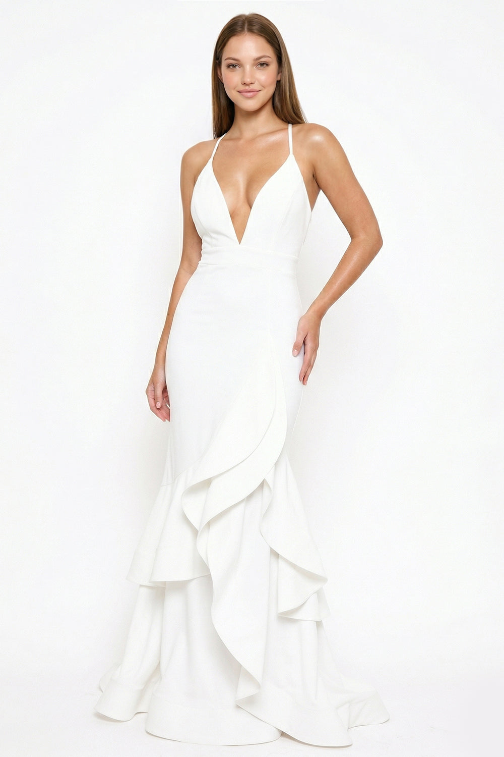 White floor-length mermaid gown with deep V-neck, spaghetti straps, and tiered ruffle skirt for formal occasions.