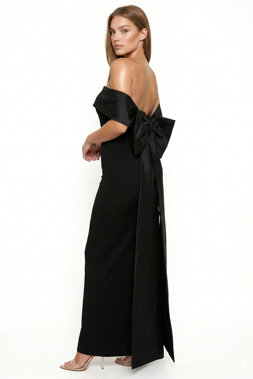 Elegant black off-the-shoulder evening gown with a large back bow, perfect for formal occasions by Boutinie.