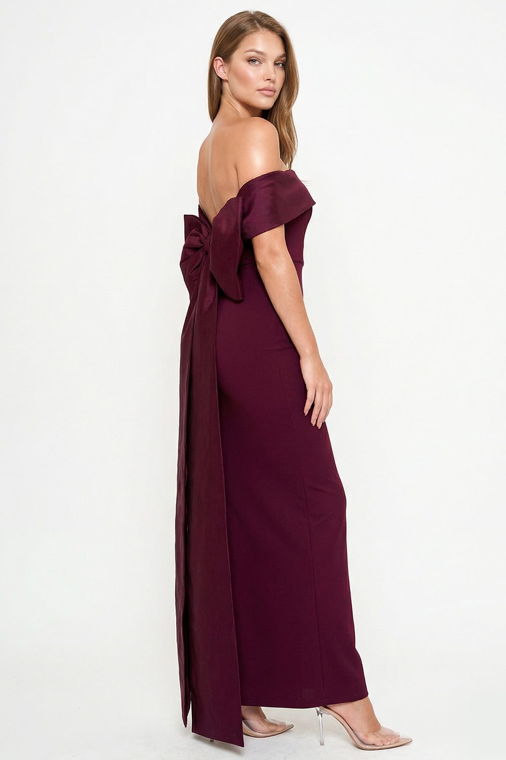Burgundy off-the-shoulder evening gown with a statement back bow, perfect for formal occasions at Boutinie.