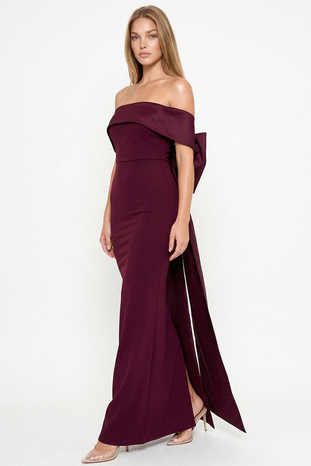 Burgundy off-shoulder formal gown with back bow detail and side slit by Boutinie for weddings or gala events.