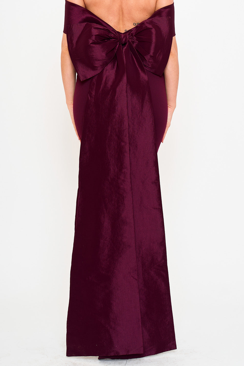 Burgundy off-the-shoulder evening gown with a dramatic back bow detail, perfect for formal occasions.