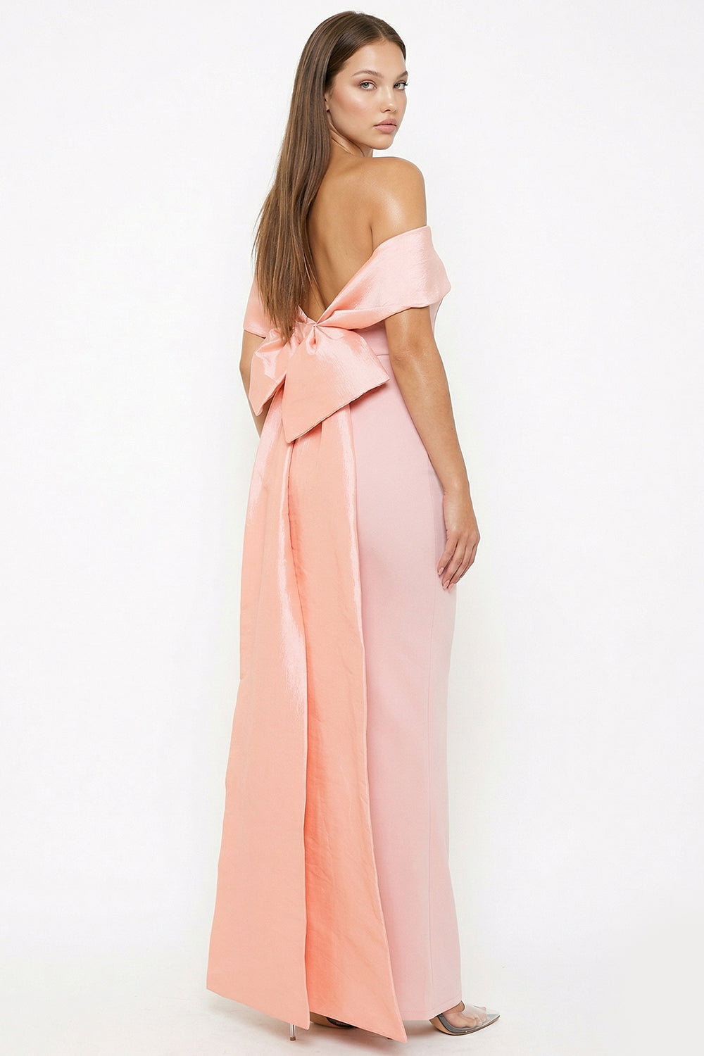 Pink off-the-shoulder formal gown with a dramatic back bow detail, perfect for weddings or red carpet events.