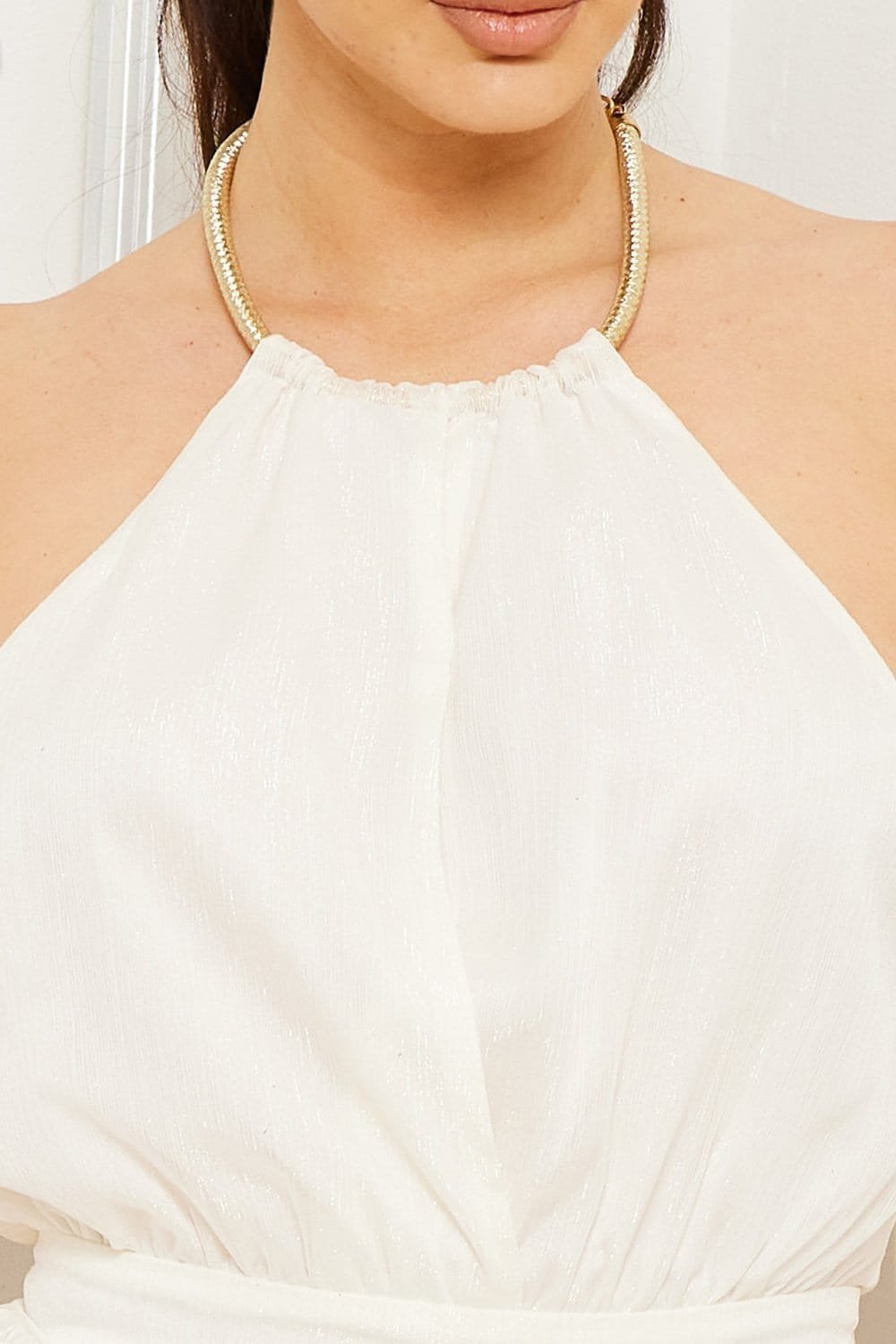 White metallic halter-neck top with gold chain strap detail, perfect for evening wear from Boutinie.