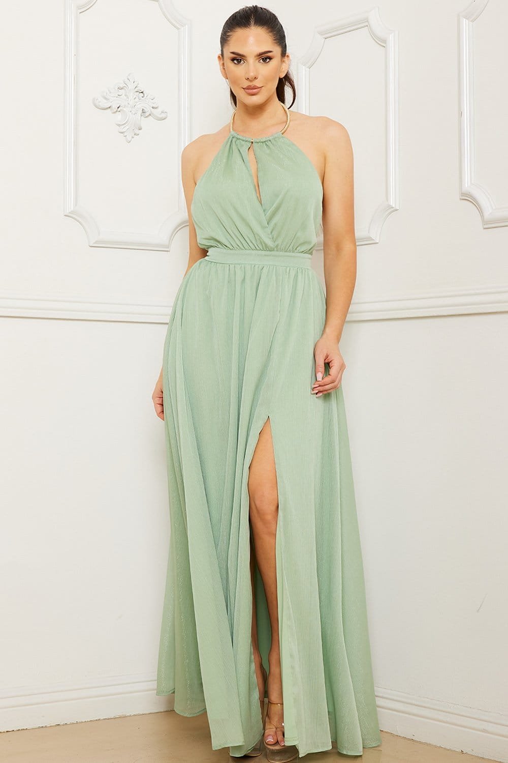 Sage green pleated maxi dress with a halter neckline, keyhole detail, and thigh-high slit for formal occasions.