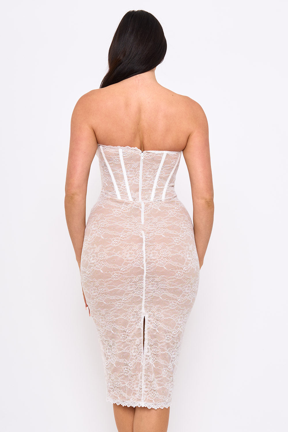 Back view of a white strapless lace midi corset dress with a fitted silhouette for formal occasions from Boutinie.