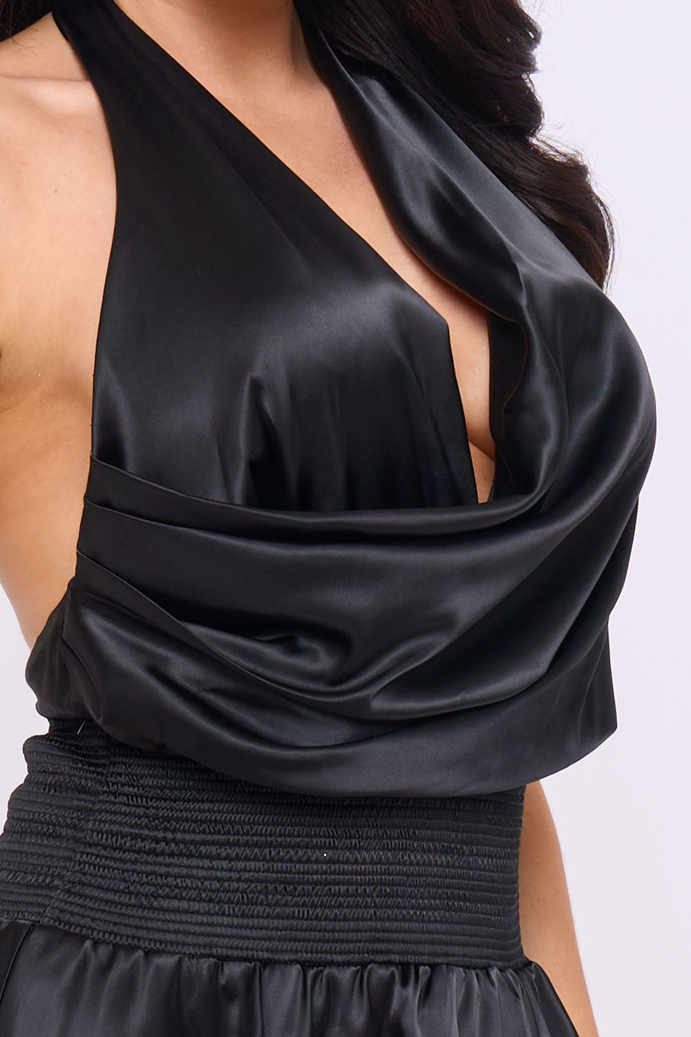 Black satin halter top with a deep cowl neckline and ruched waist, perfect for a chic evening look from Boutinie.