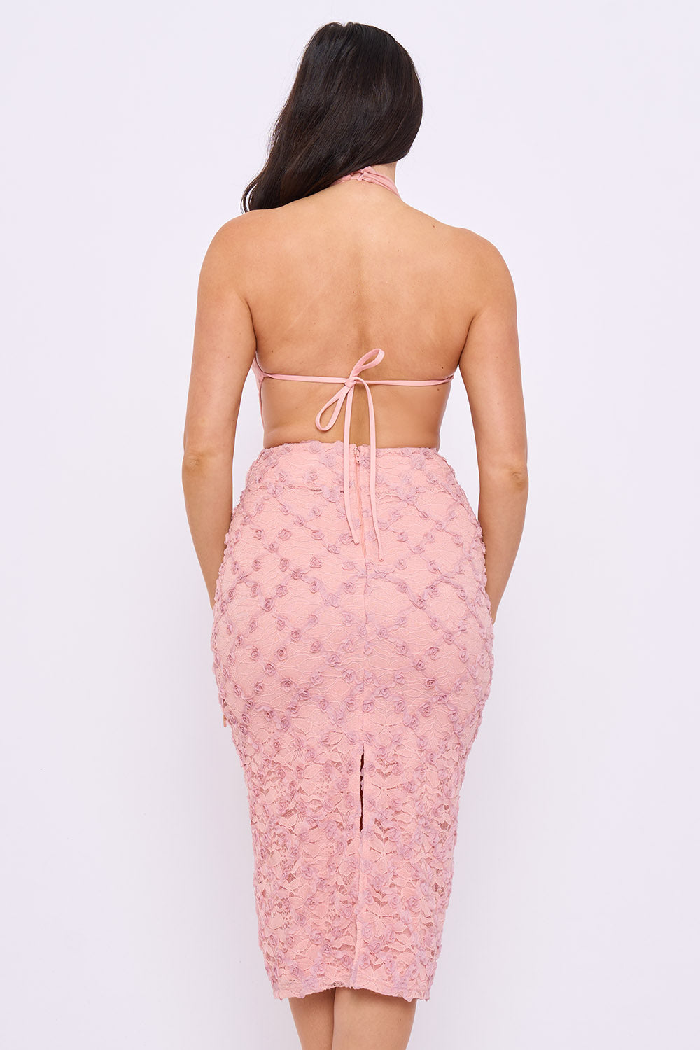 Back view of a dusty rose floral lace midi dress with a halter neck and open back tie for parties by Boutinie.