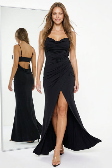 Boutinie black floor-length formal gown with cowl neckline, spaghetti straps, open back, and high leg slit.