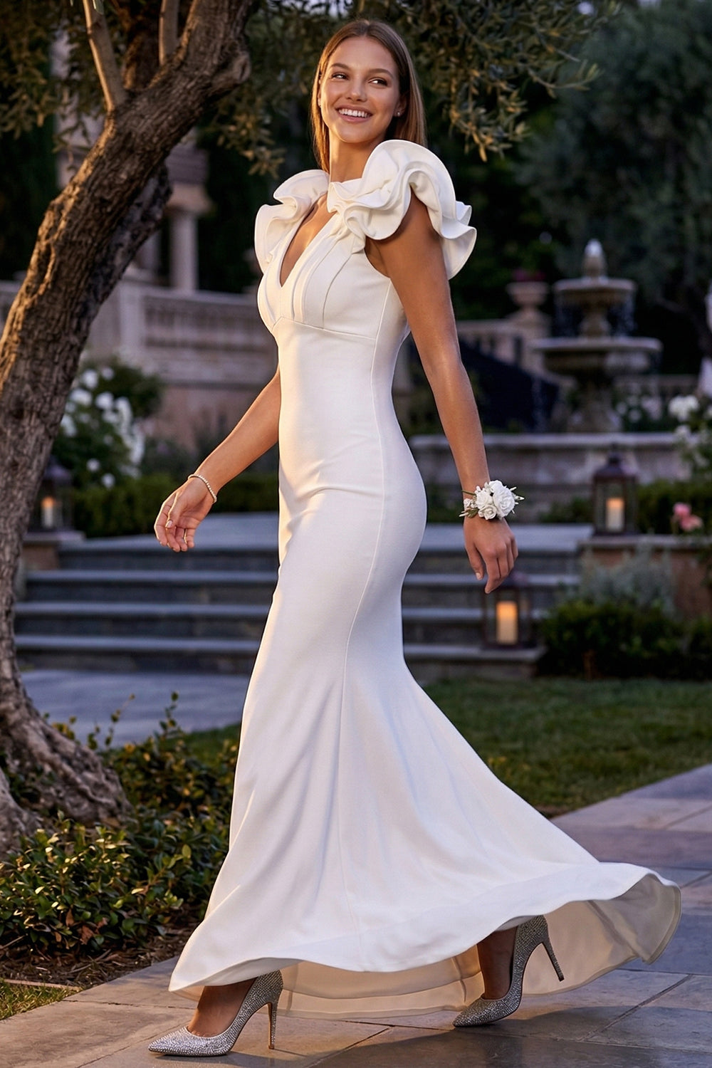 White mermaid evening gown with V-neckline and ruffled cap sleeves, perfect for formal events at Boutinie.