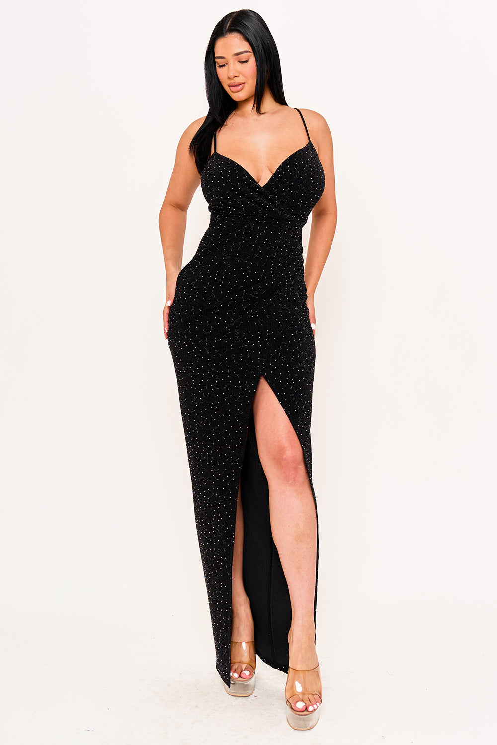 Black sleeveless maxi dress with a V-neck, high slit, and glittery fabric for an elegant evening look at Boutinie.