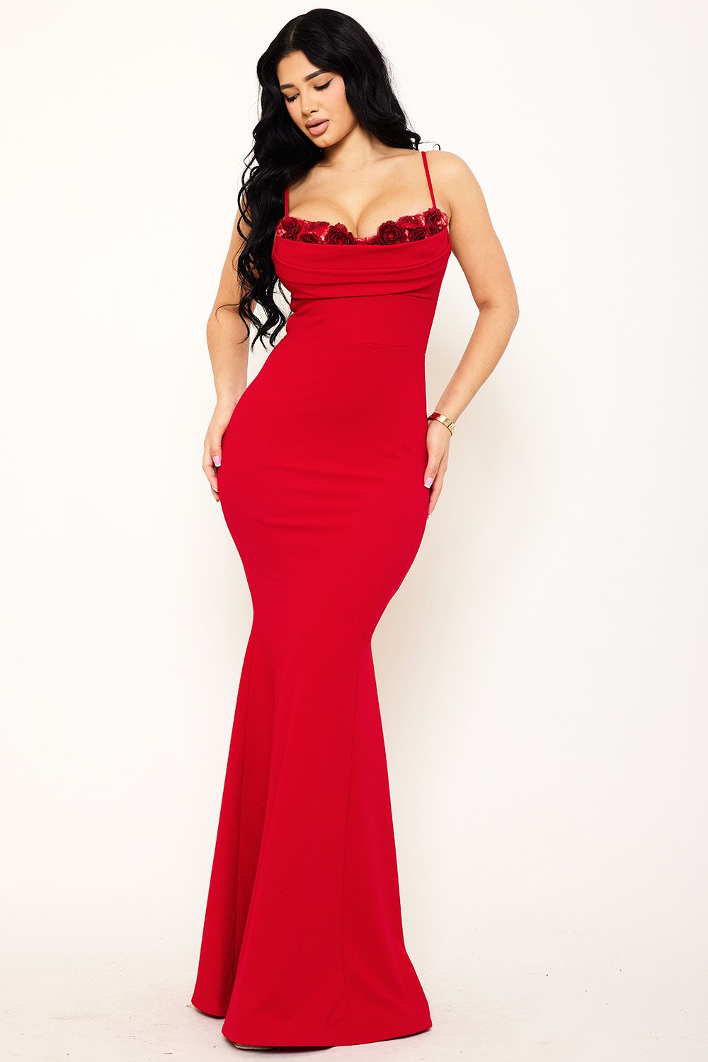 Red floor-length mermaid evening gown with spaghetti straps, draped cowl neckline, and rose-embellished bodice.