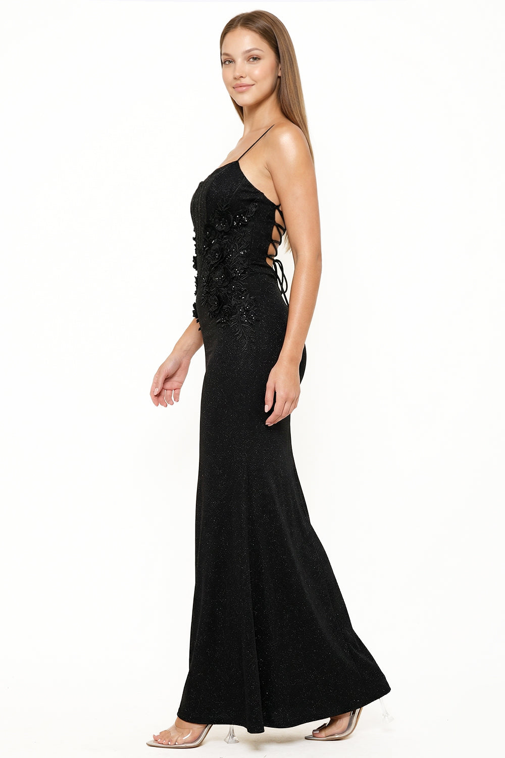 Black shimmer mermaid evening gown with floral applique, lace-up side detail, and spaghetti straps by Boutinie.