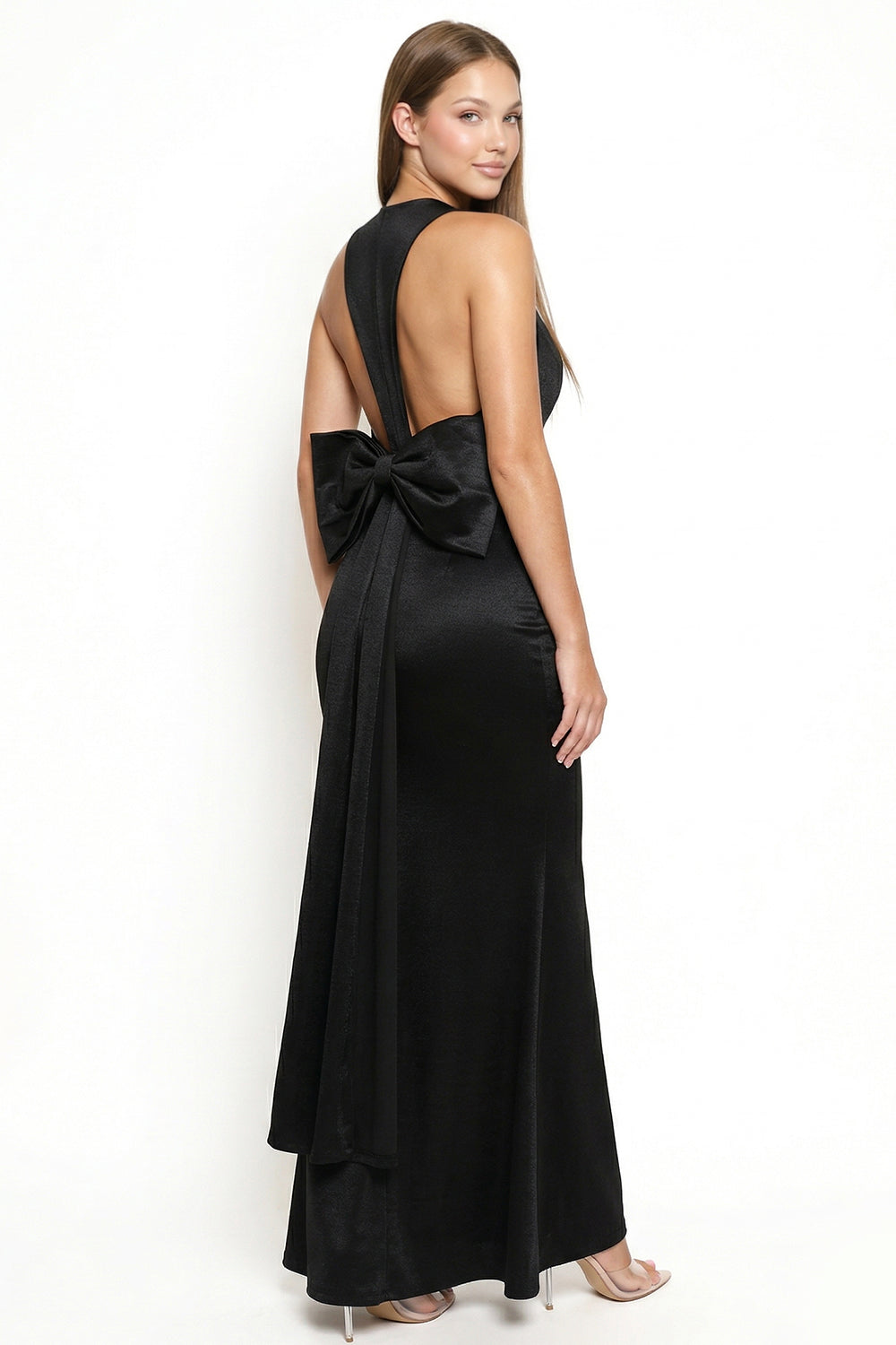 Elegant black satin floor-length evening gown with an open back and statement bow detail from Boutinie.