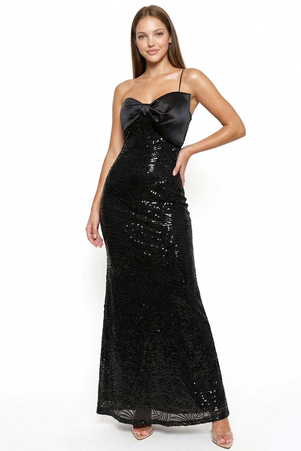 Black sequin maxi gown with a bow-detail bodice, thin straps, and fitted silhouette for an elegant evening look.