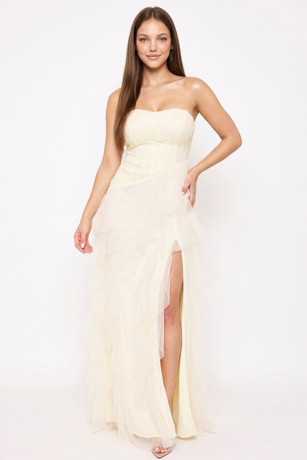 Cream strapless maxi formal dress with lace bodice, tiered tulle skirt, and high leg slit, from Boutinie.