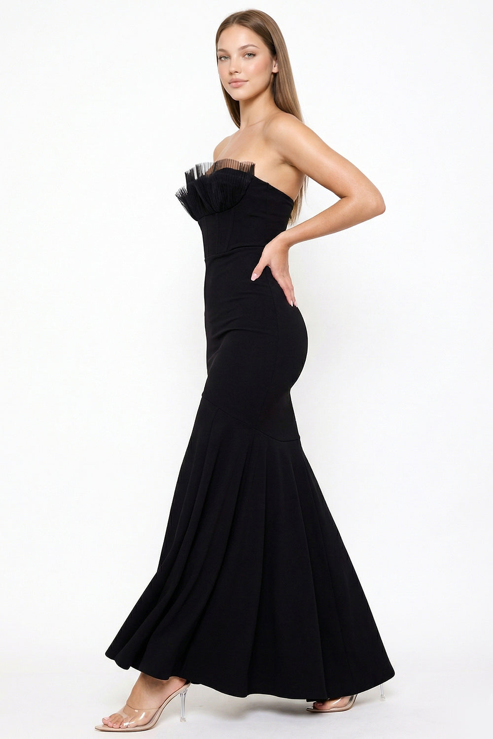 Black strapless evening gown with pleated tulle bust detail, mermaid silhouette, and floor-length skirt from Boutinie.