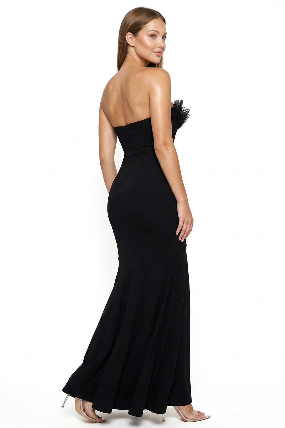 Model wearing a black strapless mermaid evening gown with feathered bust detail, perfect for formal occasions.