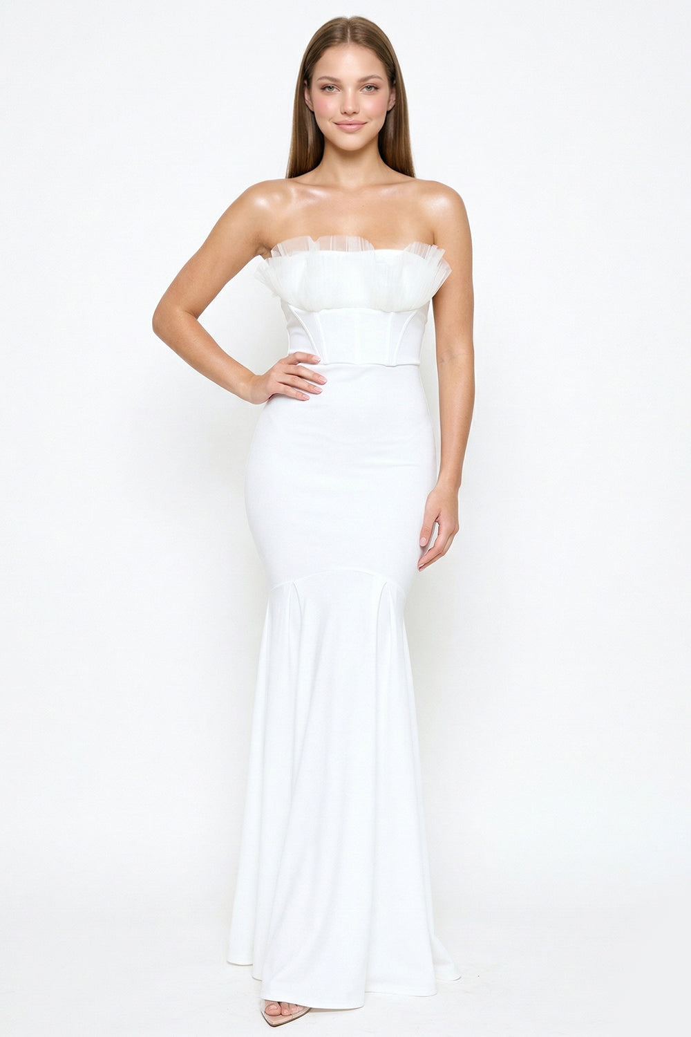 White strapless trumpet formal gown by Boutinie featuring a corset bodice and ruffled tulle neckline detail.