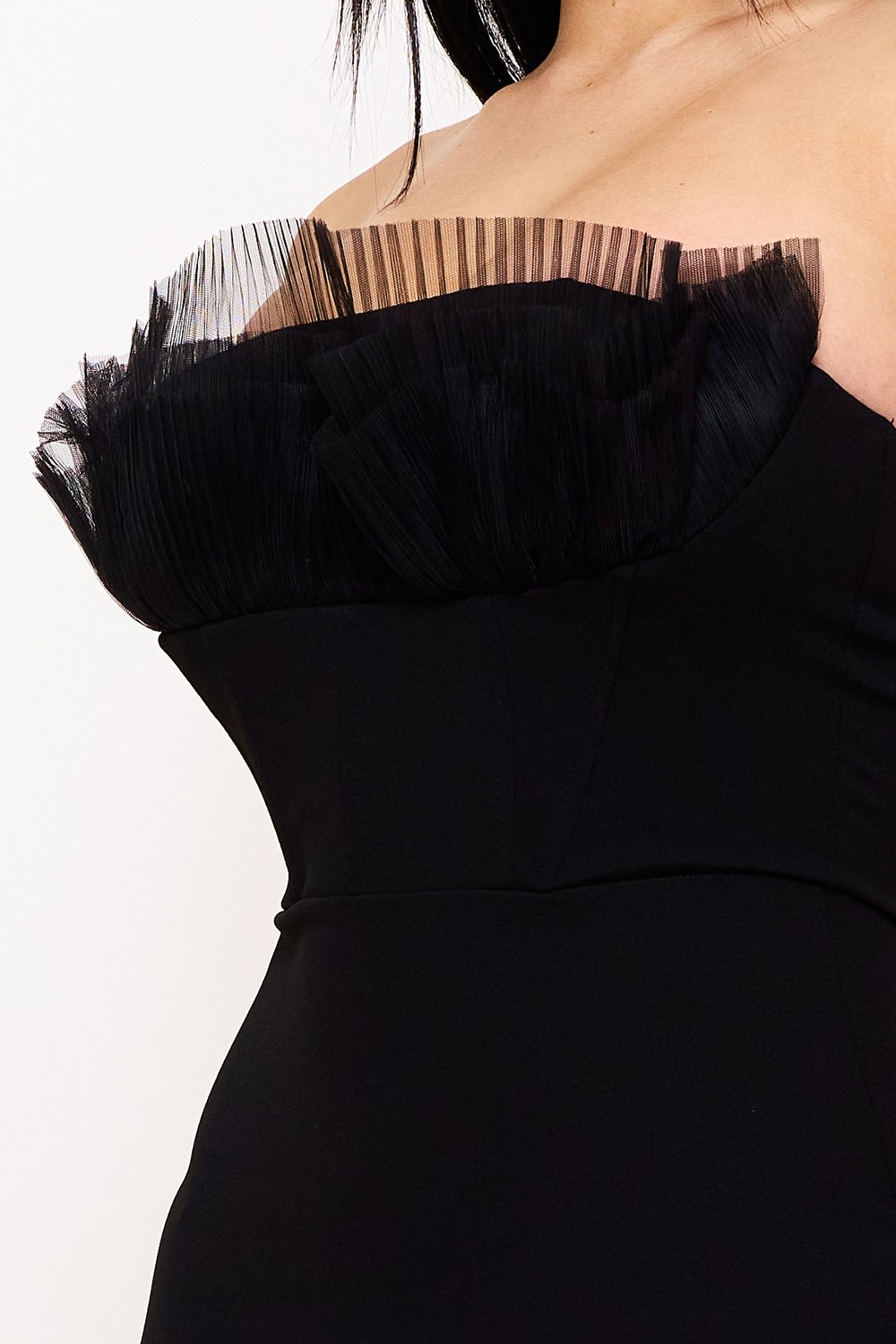 Black strapless corset dress with pleated tulle ruffle trim for an elegant evening look from Boutinie.